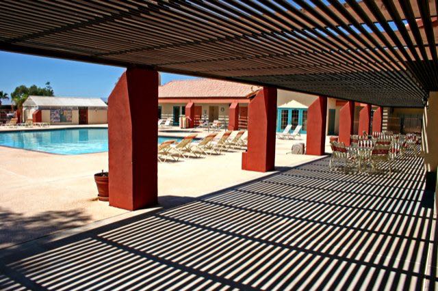 A large covered area makes the pool patio a wonderful place to relax in sun or shade.