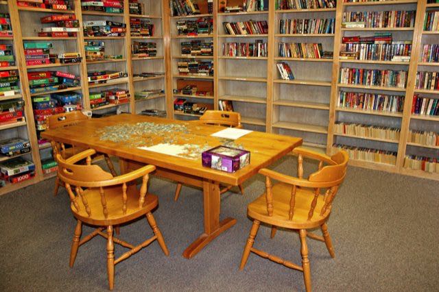 Our cozy library has a large selection of books and jigsaw puzzles.